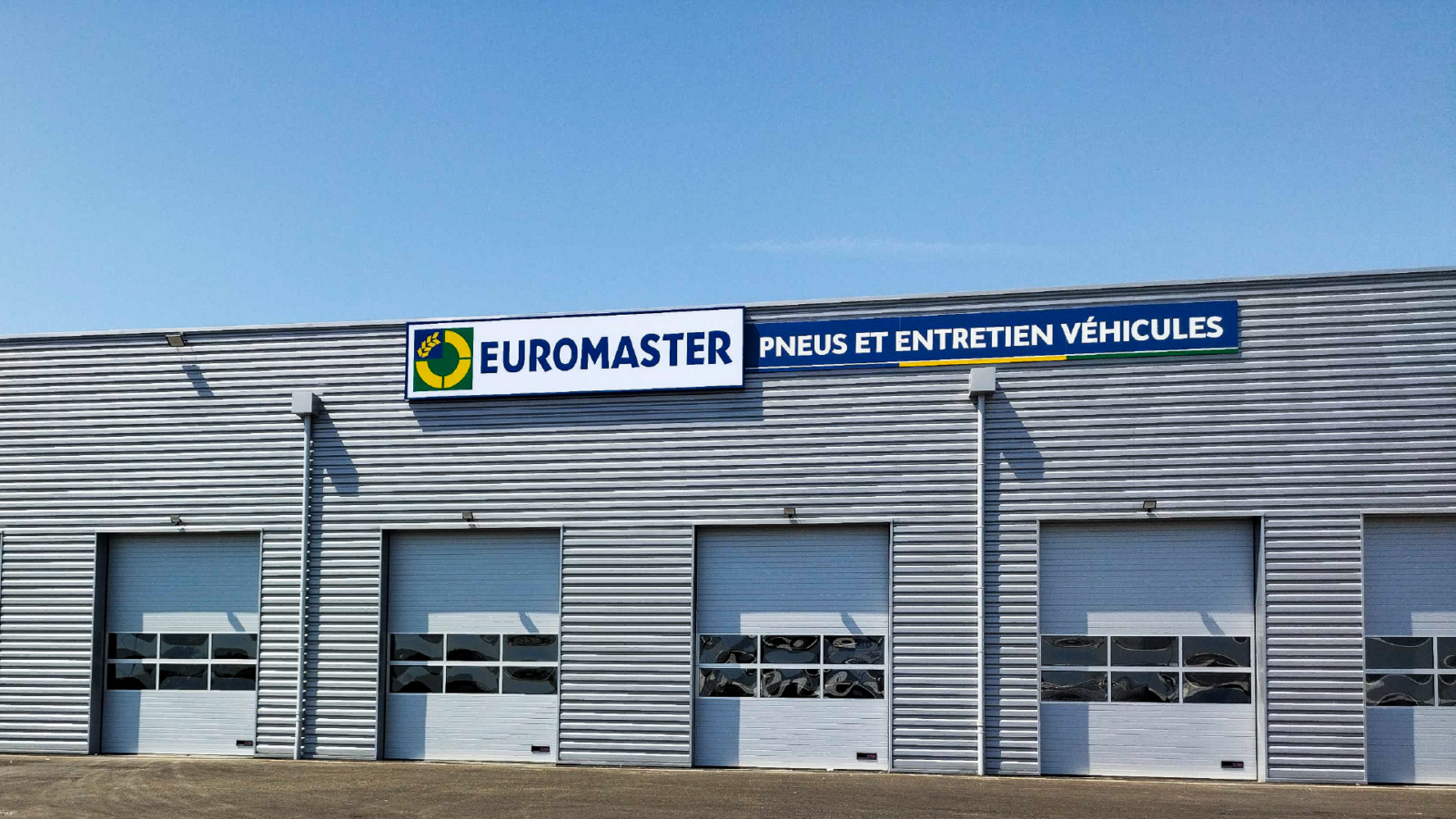 Vue globale de la façade d'un centre automobile avec enseigne lumineuse à Dijon
